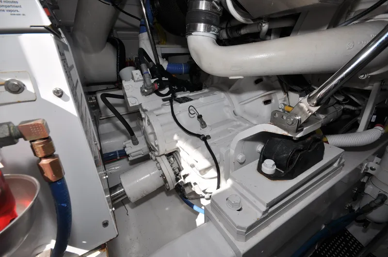 Slide: The Image of Engine room of 2019 Viking 44 Convertible yacht, showcasing mechanical components and piping. - 20