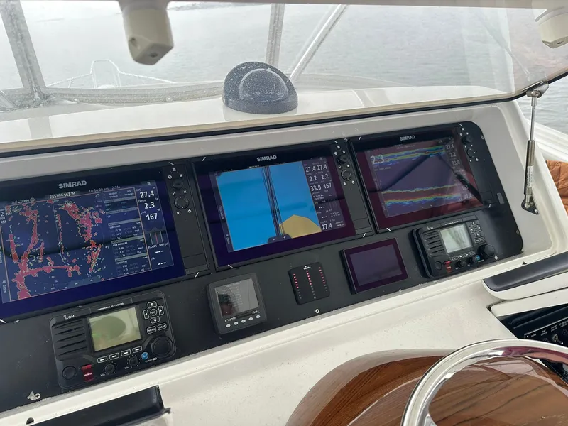 Slide: The Image of Control panel of a 2019 Viking 44 Convertible yacht with navigation screens. - 16