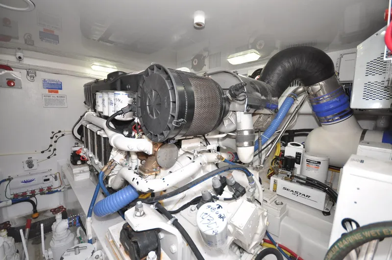 Slide: The Image of Engine room of 2019 Viking 44 Convertible yacht, showcasing complex machinery and components. - 18