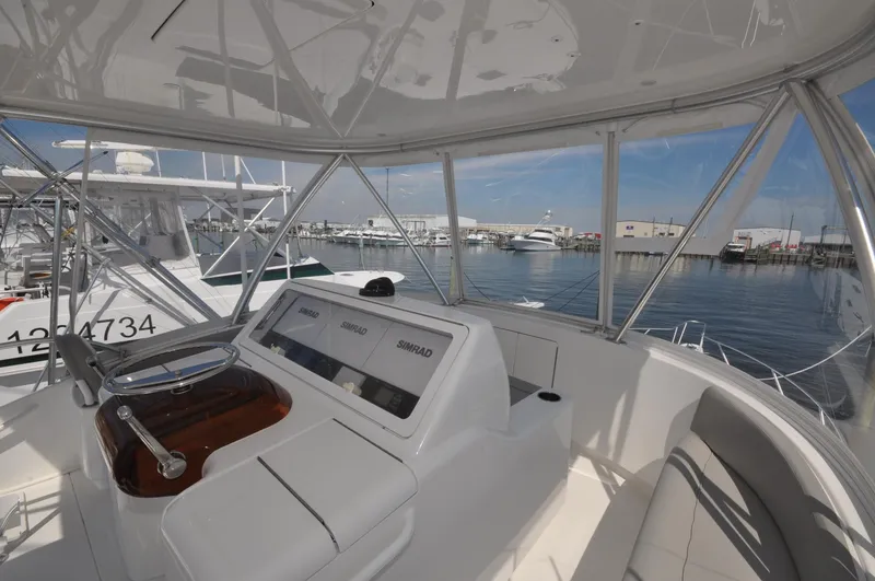 Slide: The Image of 2019 Viking 44 Convertible yacht helm with marina view. - 17