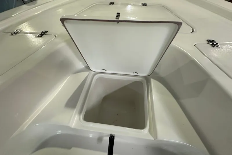 Slide: The Image of Open storage compartment on 2026 Sea Pro 230 Bay boat deck. - 11