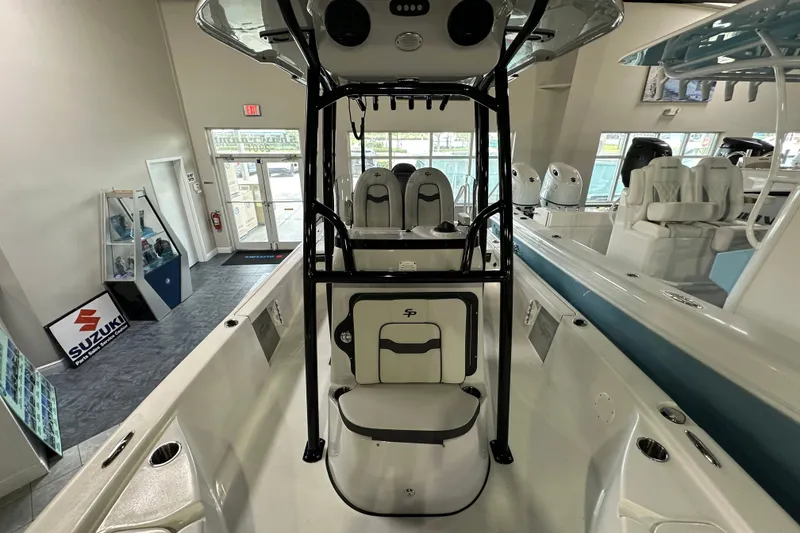 Slide: The Image of 2026 Sea Pro 230 Bay boat interior in showroom, featuring seating and console. - 12