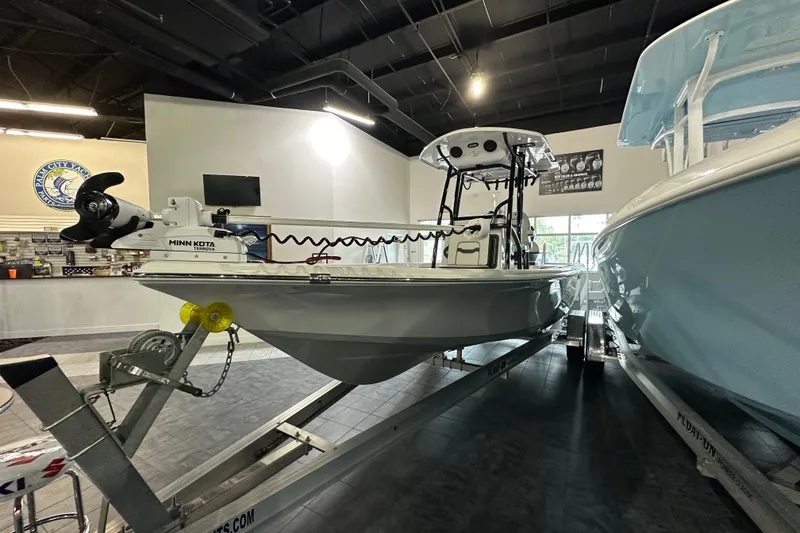 Slide: The Image of 2026 Sea Pro 230 Bay boat on display in showroom with Minn Kota trolling motor. - 1