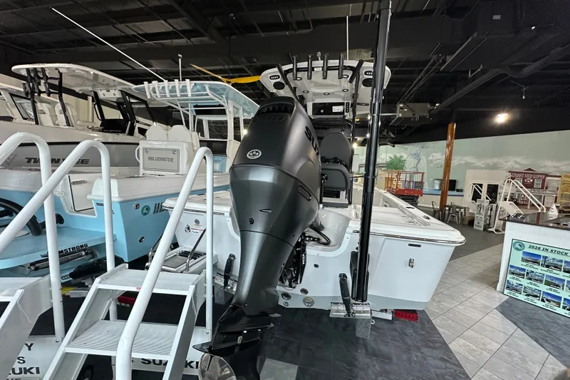 Slide: The Image of 2026 Sea Pro 230 Bay boat displayed in showroom with powerful outboard motor. - 3