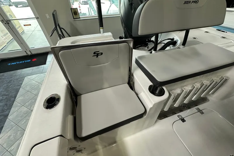 Slide: The Image of 2026 Sea Pro 230 Bay boat interior with seating and rod holders. - 16