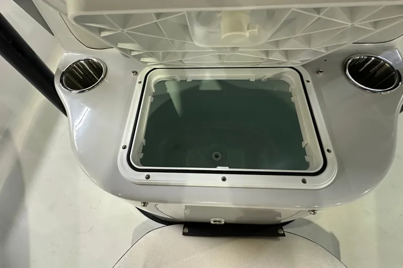 Slide: The Image of 2026 Sea Pro 230 Bay boat console with open storage compartment and dual cup holders. - 13