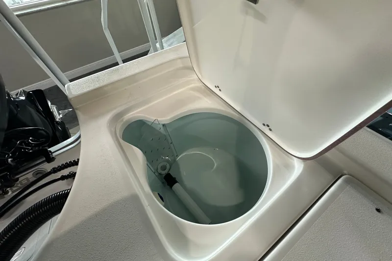 Slide: The Image of Open storage compartment on 2026 Sea Pro 230 Bay boat, showcasing interior design. - 18