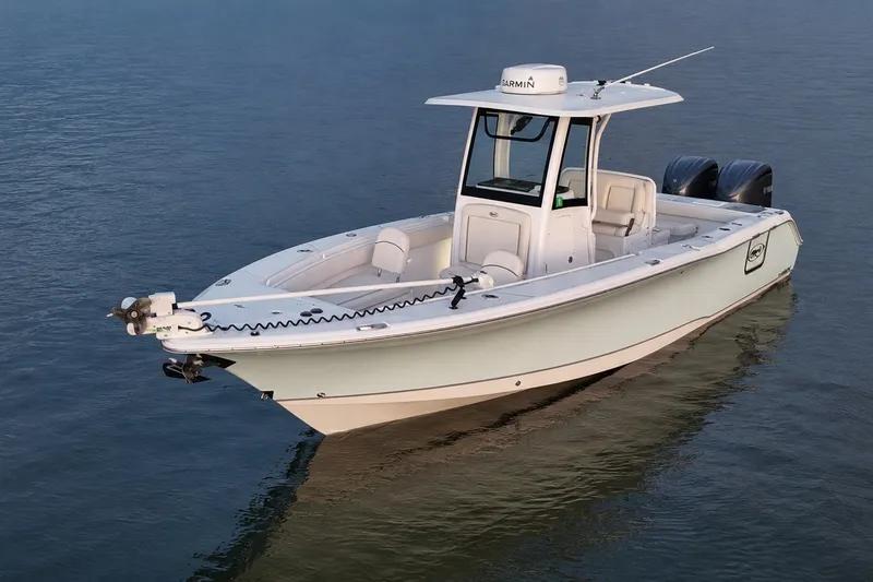 Slide: The Image of 2022 Sea Hunt Gamefish 27FS boat on calm water, featuring dual engines and sleek design. - 2