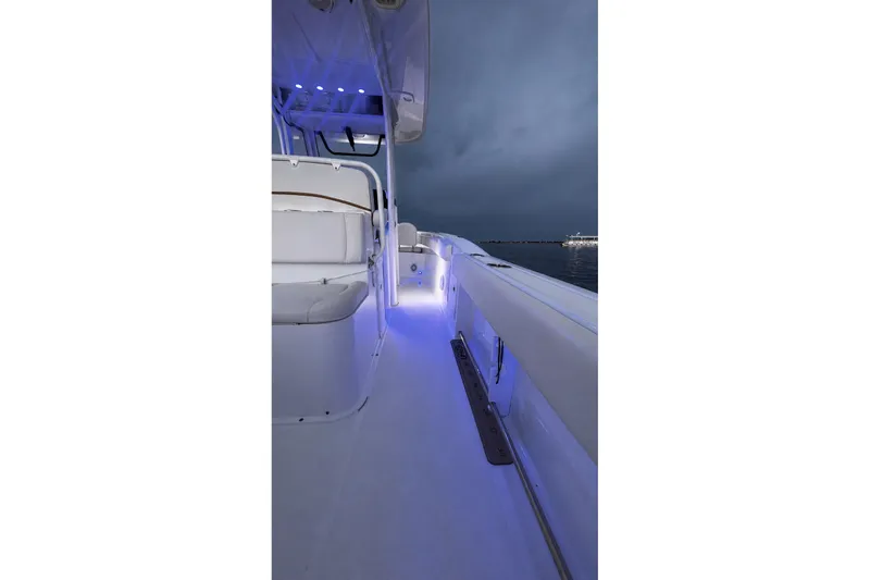 Slide: The Image of 2022 Sea Hunt Gamefish 27FS boat interior with blue LED lighting at night. - 42