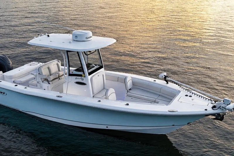 Slide: The Image of 2022 Sea Hunt Gamefish 27FS boat on calm water at sunset. - 8