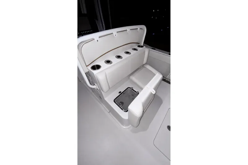 Slide: The Image of 2022 Sea Hunt Gamefish 27FS boat seating with cup holders and storage compartment. - 25