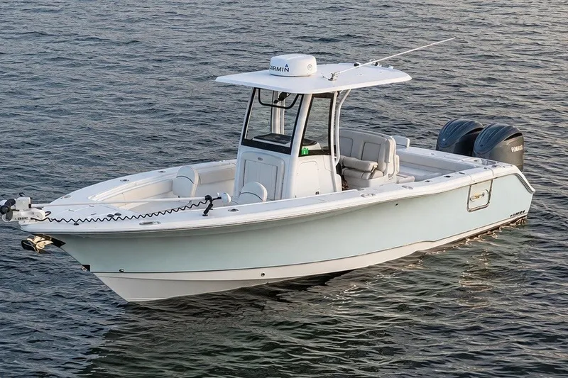 Slide: The Image of 2022 Sea Hunt Gamefish 27FS boat on calm water, featuring dual engines. - 0