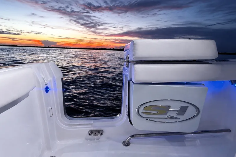 Slide: The Image of 2022 Sea Hunt Gamefish 27FS boat at sunset, featuring sleek design and ocean view. - 22