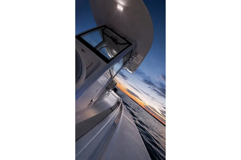 Slide: The Image of 2022 Sea Hunt Gamefish 27FS boat at sunset on the ocean. - 39