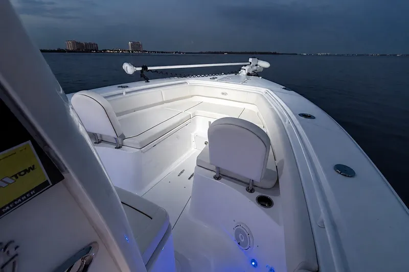 Slide: The Image of 2022 Sea Hunt Gamefish 27FS boat interior at dusk, featuring spacious seating and modern design. - 43