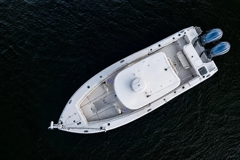 Slide: The Image of Aerial view of 2022 Sea Hunt Gamefish 27FS boat on dark water. - 10