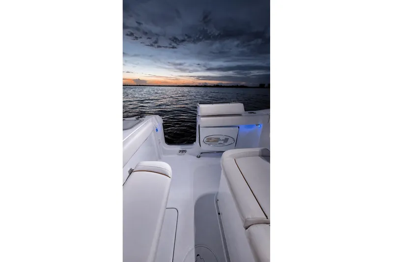 Slide: The Image of 2022 Sea Hunt Gamefish 27FS boat interior at sunset on the water. - 24