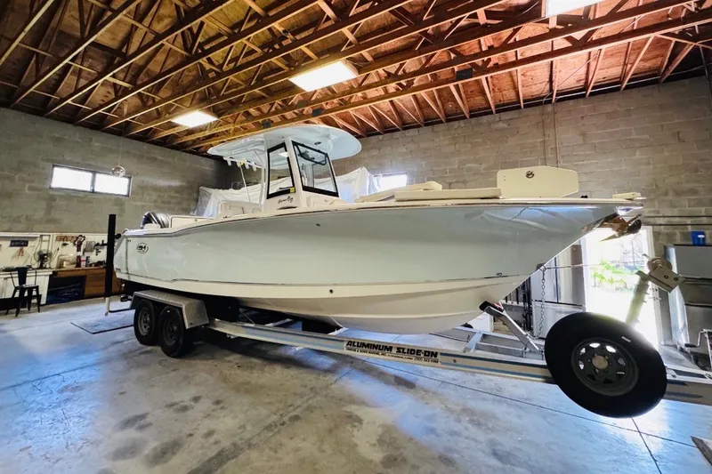 Slide: The Image of 2022 Sea Hunt Gamefish 27FS boat on trailer in a garage setting. - 32