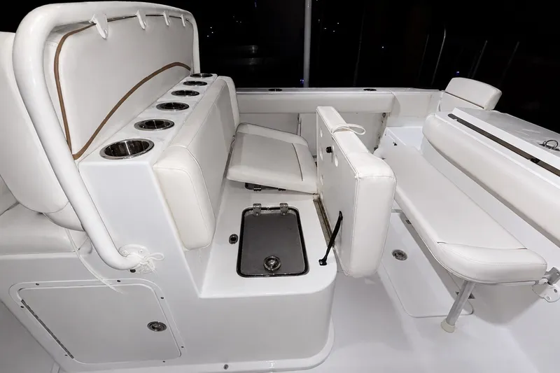 Slide: The Image of 2022 Sea Hunt Gamefish 27FS interior with white seating and cup holders. - 28