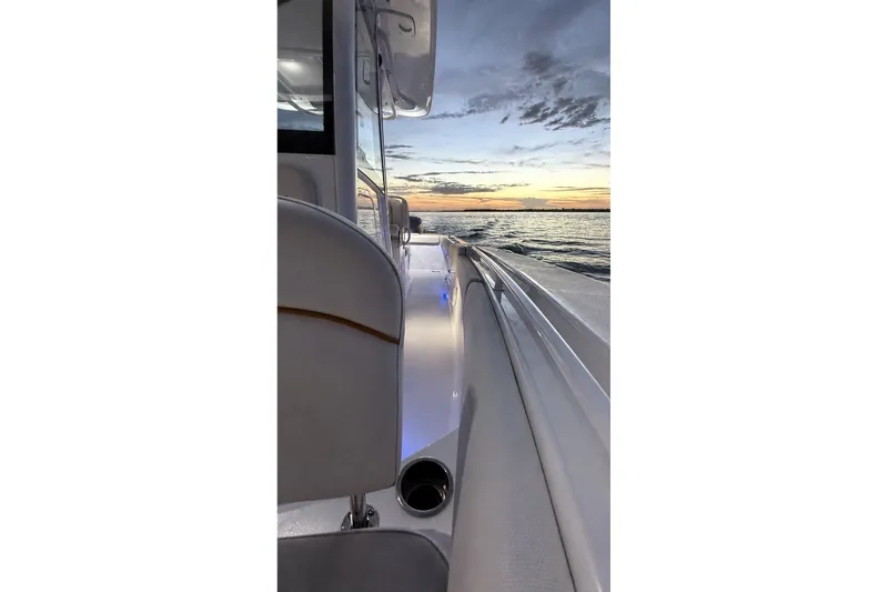 Slide: The Image of 2022 Sea Hunt Gamefish 27FS boat at sunset on the water. - 38