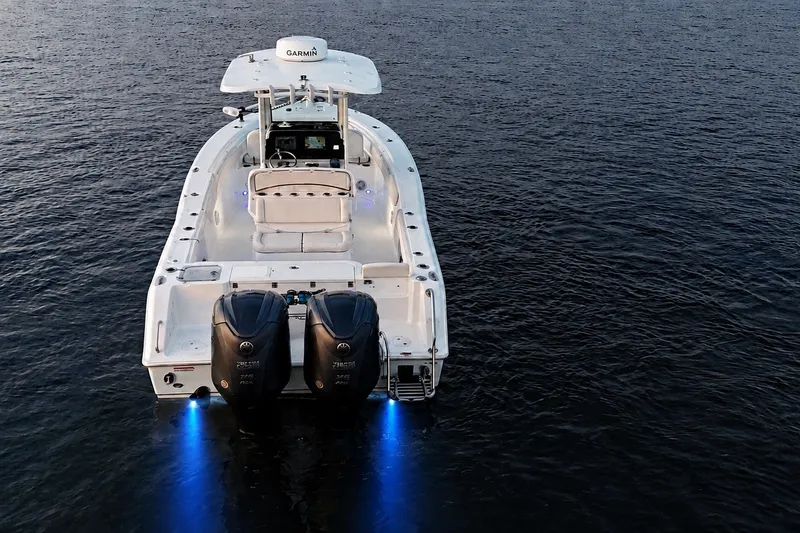 Slide: The Image of 2022 Sea Hunt Gamefish 27FS boat with dual engines on calm water. - 11