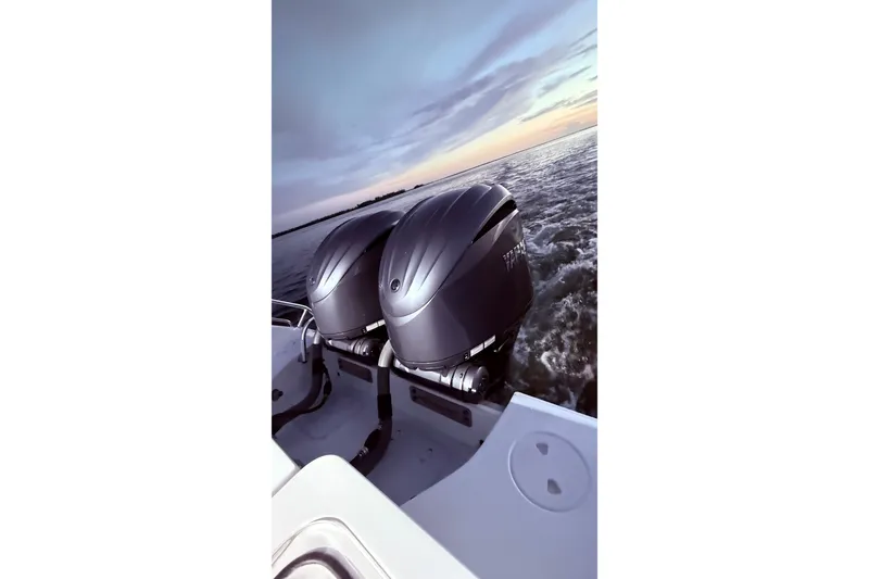 Slide: The Image of 2022 Sea Hunt Gamefish 27FS boat with dual engines cruising at sunset. - 37