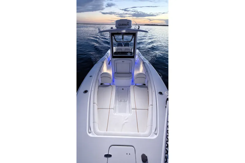 Slide: The Image of 2022 Sea Hunt Gamefish 27FS boat at sunset, featuring sleek design and illuminated seating. - 40