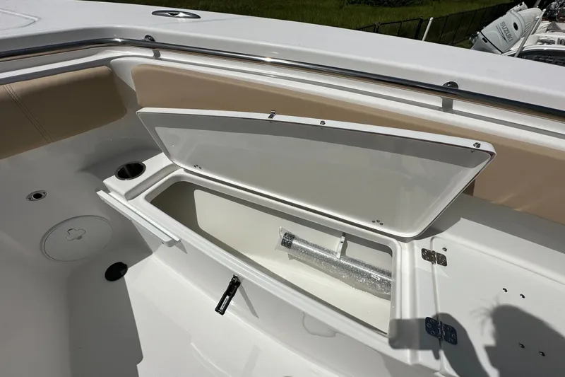 Slide: The Image of 2026 Sea Pro 262 Offshore boat storage compartment with open lid, showcasing interior space. - 6