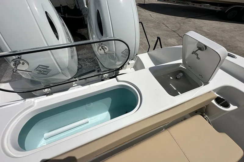 Slide: The Image of 2026 Sea Pro 262 Offshore boat with open storage compartments and dual engines. - 13