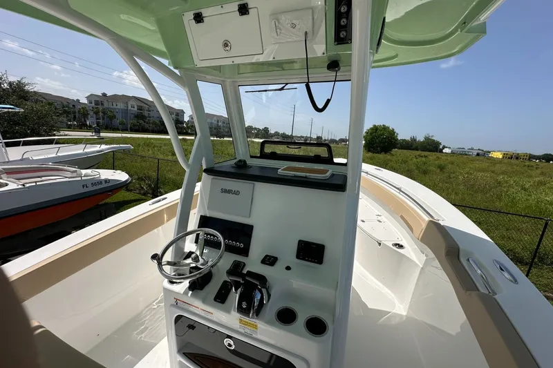 Slide: The Image of 2026 Sea Pro 262 Offshore boat helm with steering wheel and navigation equipment. - 3