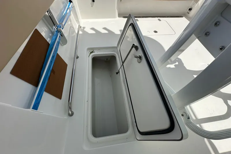 Slide: The Image of Open storage compartment on 2026 Sea Pro 262 Offshore boat deck. - 10