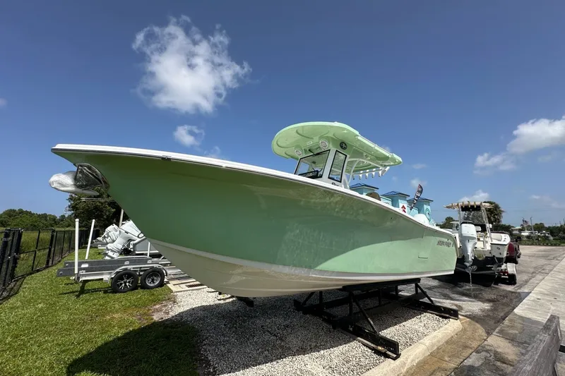 Slide: The Image of 2026 Sea Pro 262 Offshore boat displayed outdoors on a sunny day. - 1