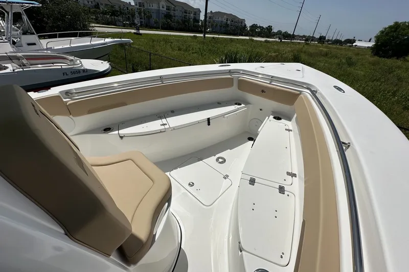 Slide: The Image of 2026 Sea Pro 262 Offshore boat interior with seating and storage compartments. - 4