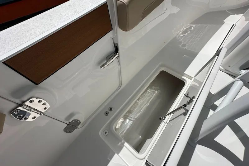 Slide: The Image of Interior view of 2026 Sea Pro 262 Offshore boat, featuring storage compartment and sleek design. - 11