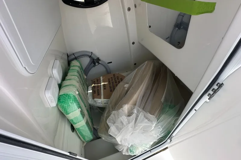 Slide: The Image of Storage compartment of 2026 Sea Pro 262 Offshore boat with packaged items. - 8