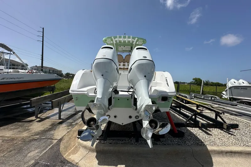 Slide: The Image of 2026 Sea Pro 262 Offshore boat with dual outboard motors on a sunny day. - 2
