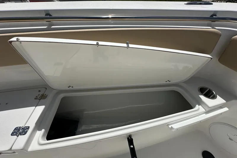 Slide: The Image of Open storage compartment on 2026 Sea Pro 262 Offshore boat, featuring sleek design and cup holder. - 5