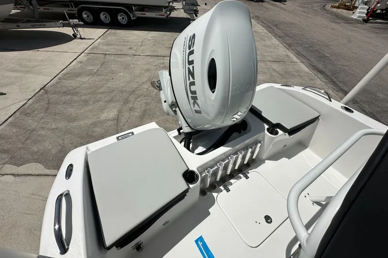 Slide: The Image of 2026 Sea Pro 202 Center Console boat with Suzuki outboard motor, docked on concrete. - 9