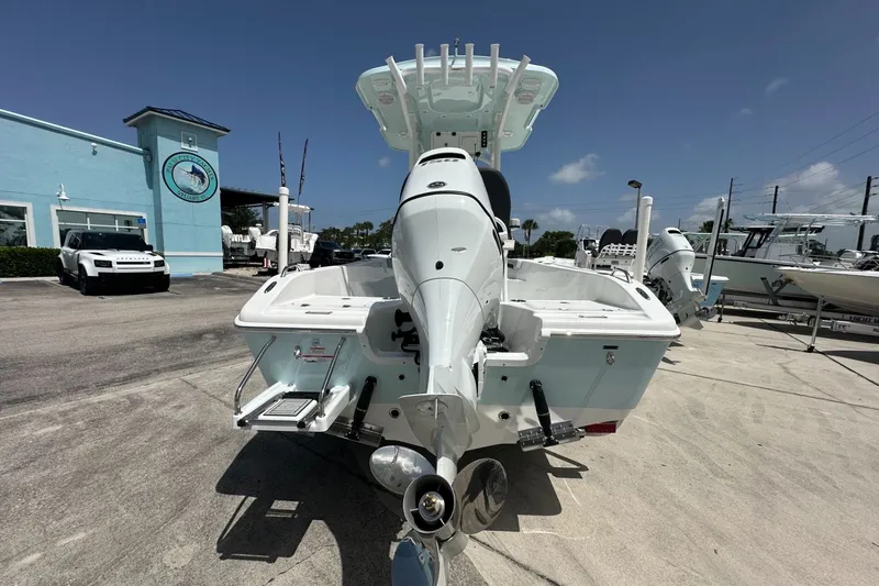 Slide: The Image of 2026 Sea Pro 202 Center Console boat displayed outdoors at a dealership. - 2