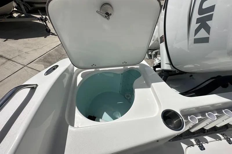 Slide: The Image of 2026 Sea Pro 202 Center Console boat with open livewell and Suzuki engine. - 10