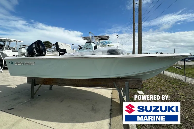 The Image of 2026 Sea Pro 210 Bay boat with Suzuki Marine engine on display outdoors. - 0