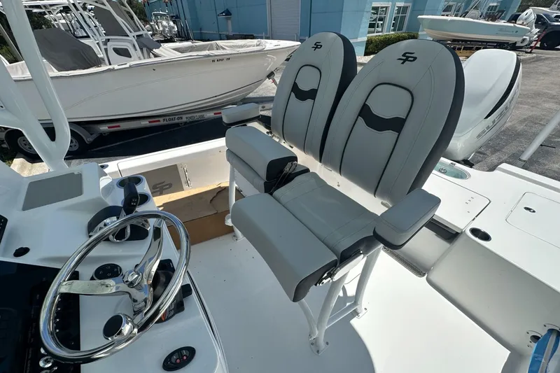 Slide: The Image of 2026 Sea Pro 250 Bay boat interior with dual seats and steering wheel. - 9