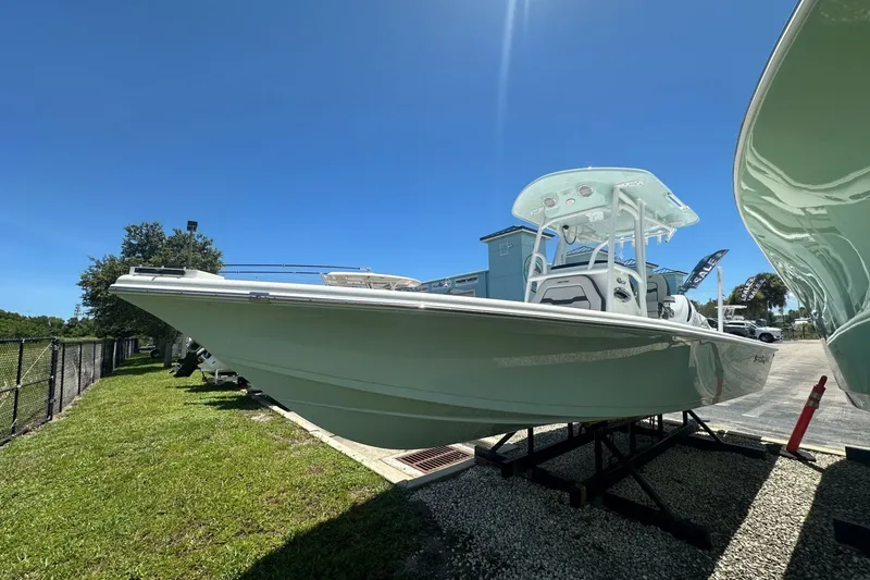 Slide: The Image of 2026 Sea Pro 250 Bay boat displayed outdoors under clear blue sky. - 1