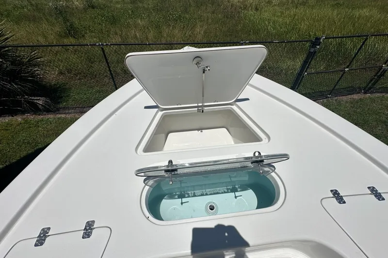 Slide: The Image of Open storage compartments on 2026 Sea Pro 250 Bay boat deck. - 6
