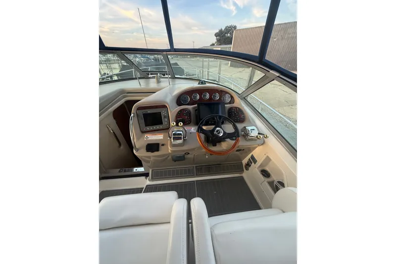 Slide: The Image of 2007 Sea Ray 340 Sundancer helm with modern controls and navigation instruments. - 13