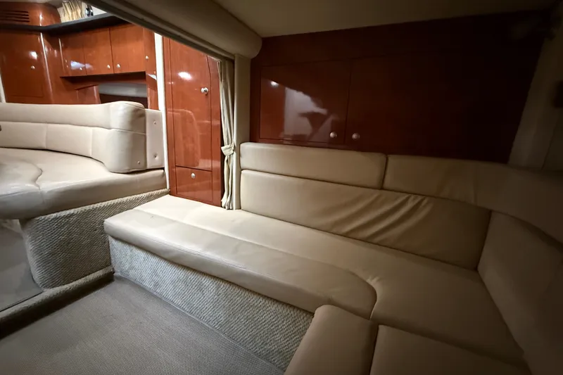 Slide: The Image of Interior of 2007 Sea Ray 340 Sundancer yacht with beige seating and wooden cabinetry. - 24