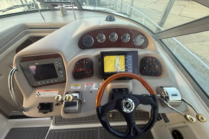 Slide: The Image of 2007 Sea Ray 340 Sundancer helm with navigation controls and steering wheel. - 14