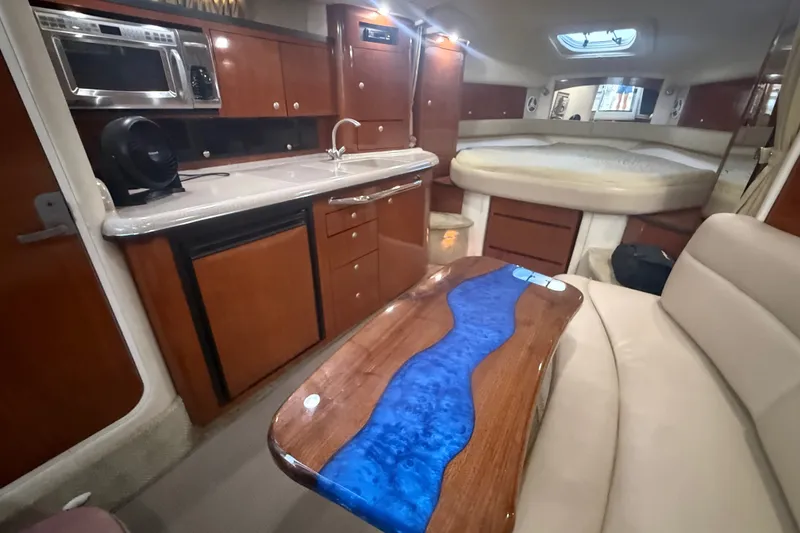 Slide: The Image of Interior of 2007 Sea Ray 340 Sundancer yacht with modern kitchen and cozy seating area. - 17
