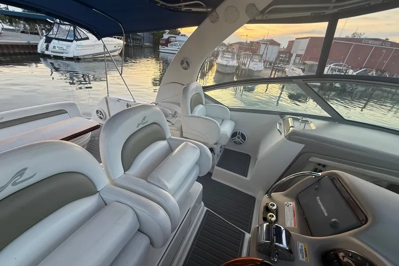 Slide: The Image of Luxurious 2007 Sea Ray 340 Sundancer interior with plush seating at sunset in marina. - 15