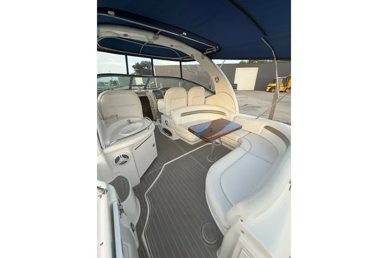Slide: The Image of 2007 Sea Ray 340 Sundancer interior with white seating and wooden table. - 10